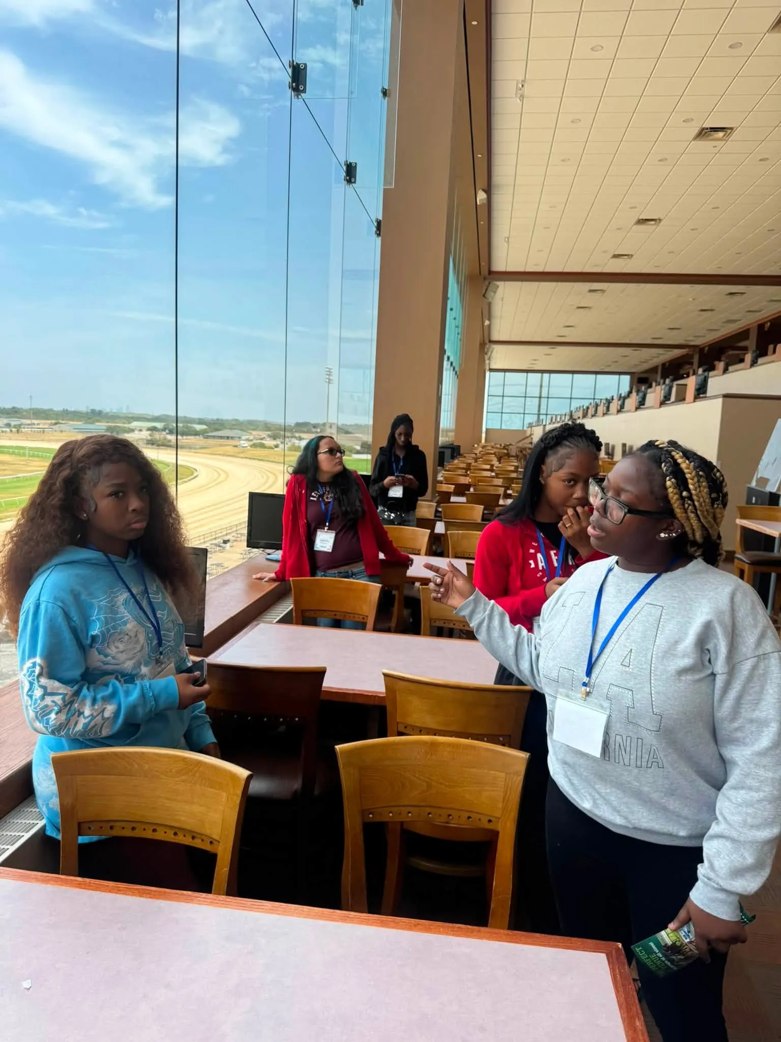 A mentor talking with girls at Dream It Be It, 2026