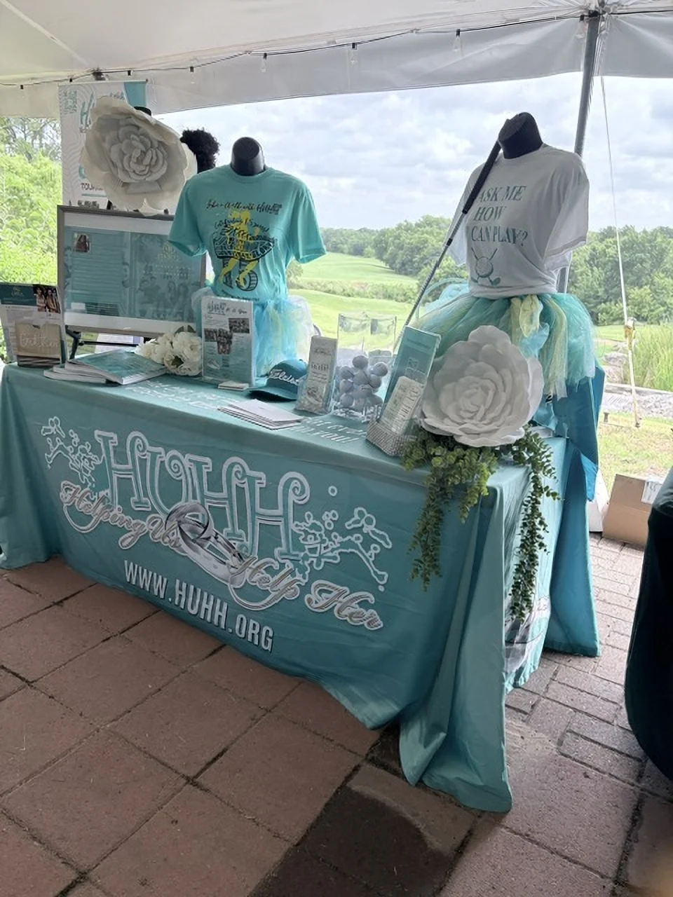 The HUHH table under the tent at the tournament