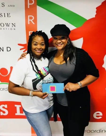 A HUHH participant and a program leader at a community event